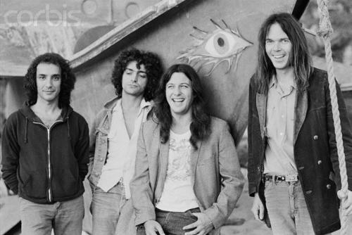 ca. 1975, Malibu, California, USA --- Neil Young (right) and the members of his band Crazy Horse: Ralph Molina, Billy Talbot, and Frank Sampedro. --- Image by © Henry Diltz/CORBIS